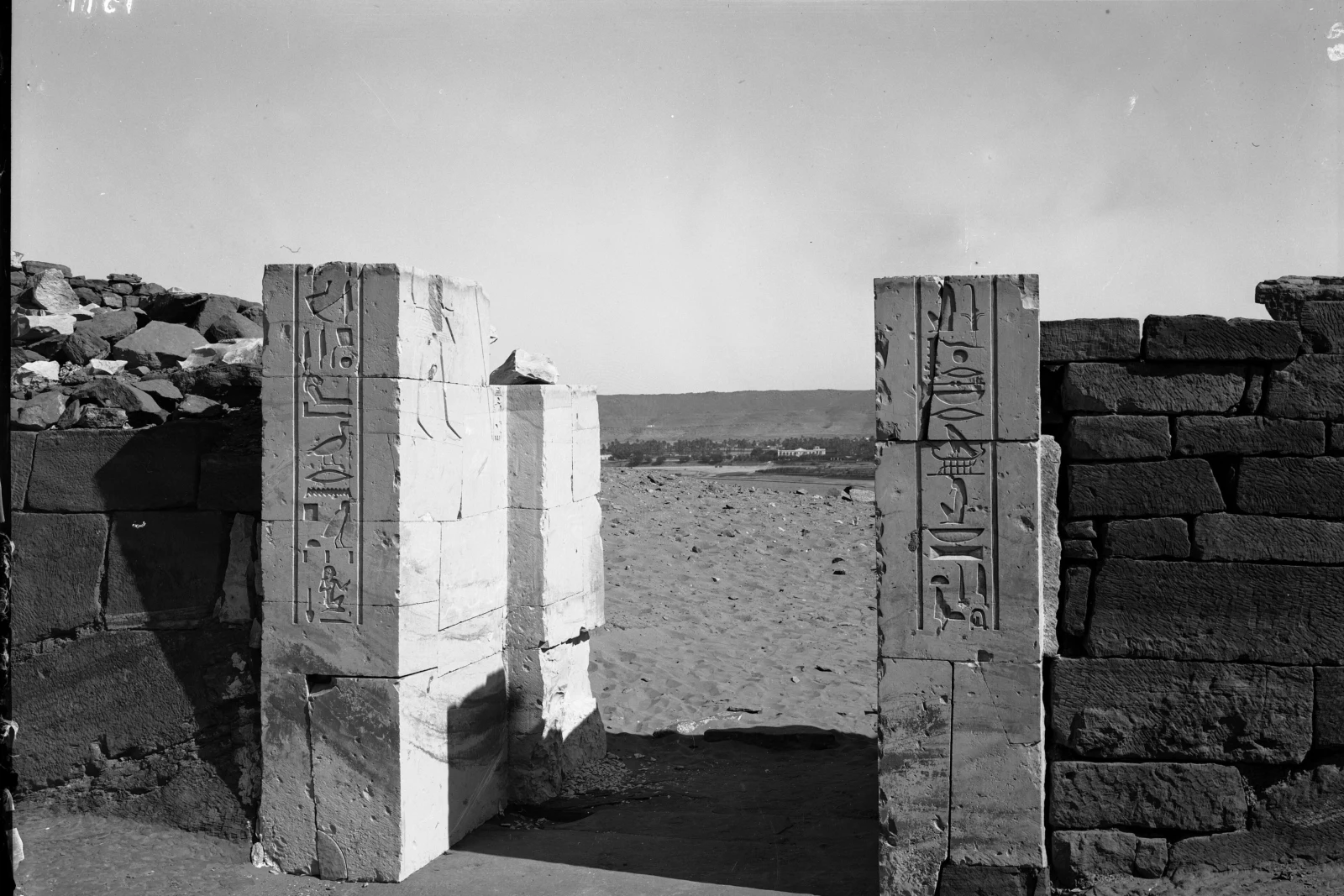 Archaeological remains against the desert cliffs in Aswan
